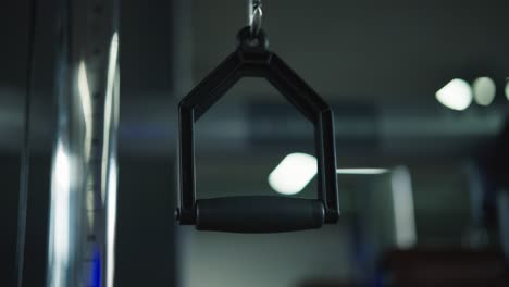 single pulley handle hang from indoor weightlifting gym equipment