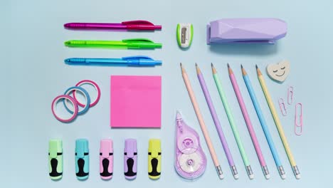 pink pencil case packs colorful stationery in stop motion on light blue, leaving wide copy space, then reversing as a loop