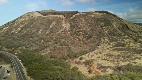 Aerial-view-of-Koko-crater-with-clouds-and-blue-skies-tracking-forward