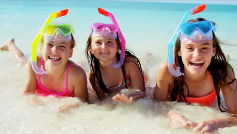 portrait of caucasian girls on beach going snorkeling