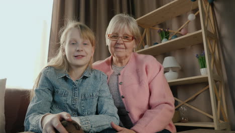 grandmother and granddaughter speak to camera during video call