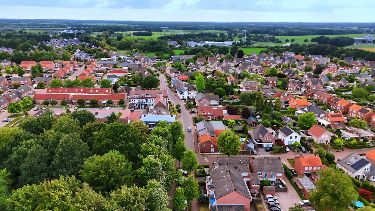 Aerial view of a Dutch town and countryside. Drone photo showing a Dutch town with houses, streets, and surrounding green countryside fields