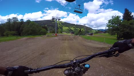 pov from the front of a bmx dirt bike biking on a muddy outdoor course in les gets france