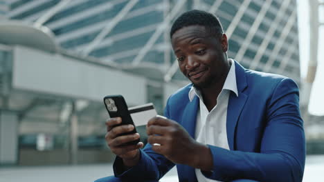 businessman using smartphone and credit card for online transaction