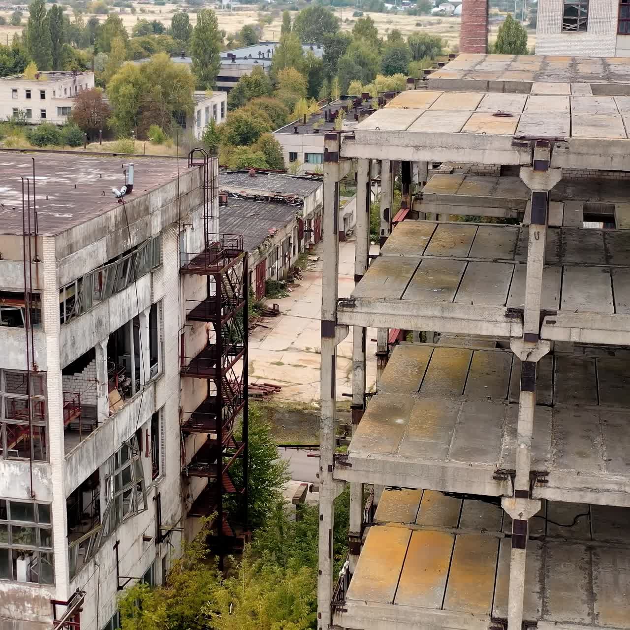 Empty unfinished industrial building. Exterior of abandoned building of an old factory without windows. Ruined architecture after war times