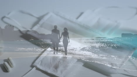video compuesto digital de máscara facial, desinfectante y píldoras contra pareja caminando en la playa