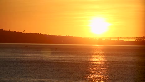 the 25th of april bridge under a fantastic sunrise over the tagus river