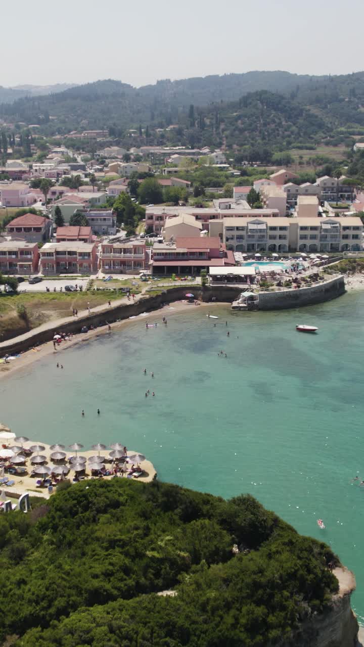 Aerial Vertical of Sidari’s coast, revealing sandy beaches, clear Ionian waters, and the vibrant resort atmosphere of Corfu