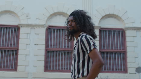 cool and fashionable black man walks in the streets of old town