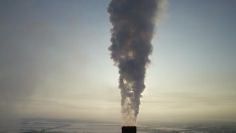 smokestack emissions over a city in winter