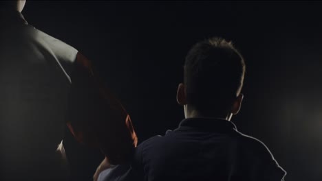 two boys being watched by a man
