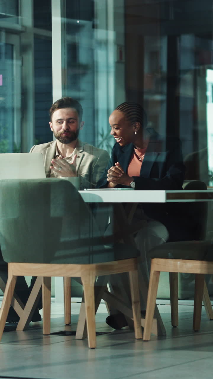 Diverse Business Colleagues Collaborating and Laughing in a Modern Office Meeting