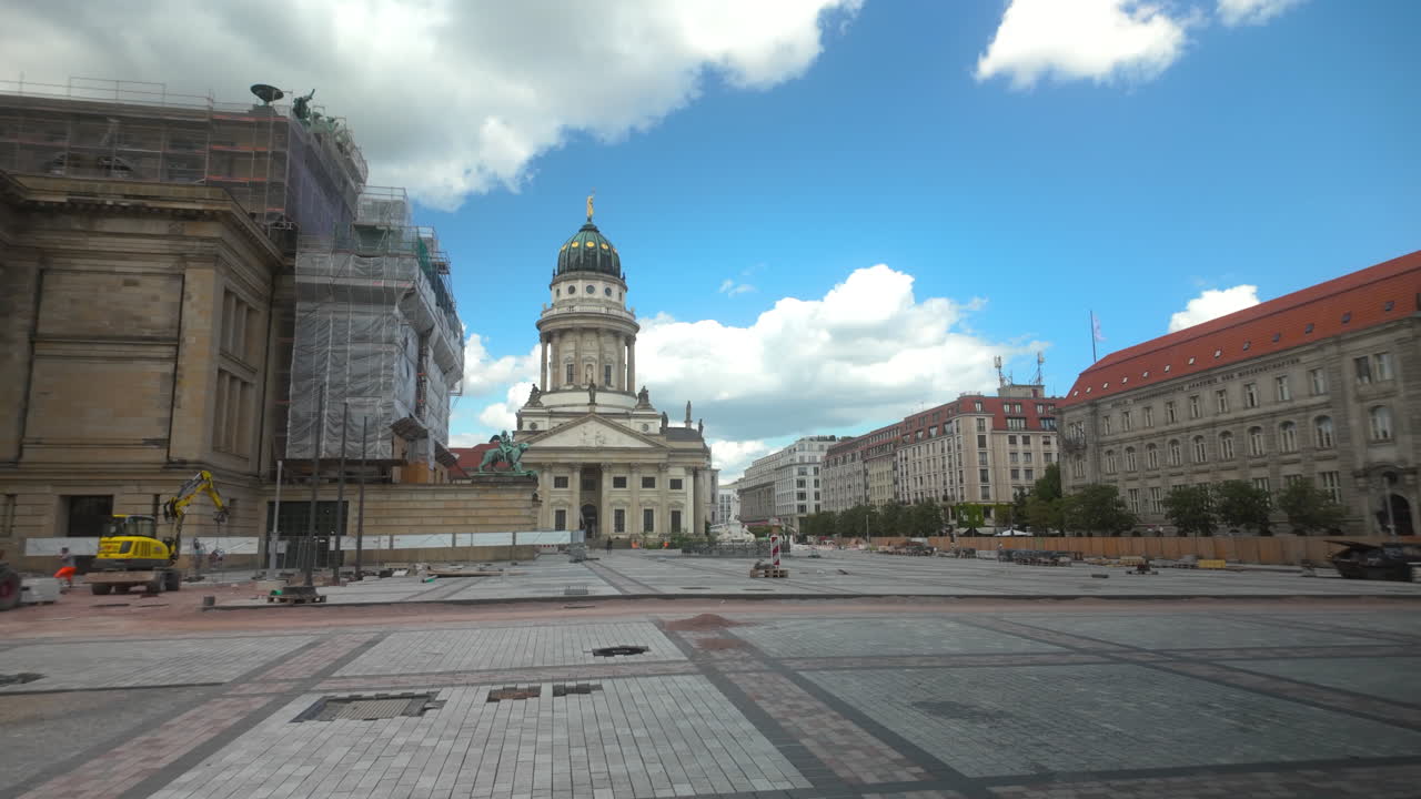Wide view of Berlin’s Gendarmenmarkt square with historical buildings under renovation