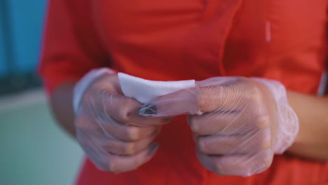 doctor in uniform and transparent gloves with wet wipe