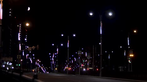 night view of a city street with illuminated lamp posts