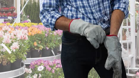 animation of caucasian male worker wearing gloves over garden