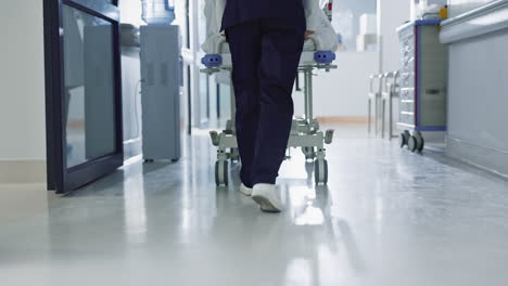Patient,-bed-and-nurse-walking-in-hospital