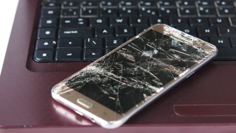 Broken Smartphone on Laptop Keyboard