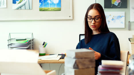 Female-executive-using-mobile-phone