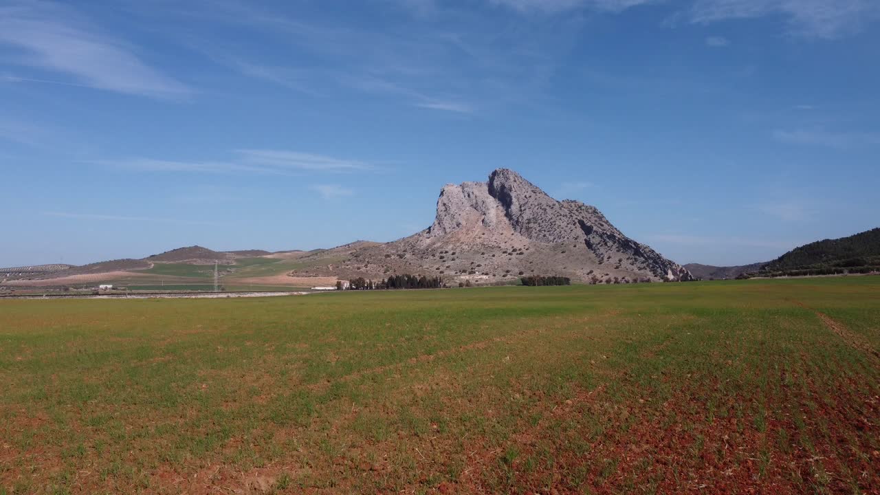Spectacular aerial flight over the enclave of Pe&ntilde;a de los Enamorados, a rock formation in the shape of a human face in the municipality of Antequera in Andalusia, Spain