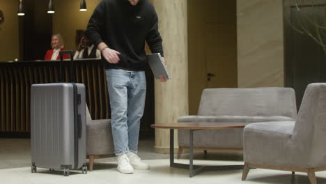 guest working on laptop at hotel hall