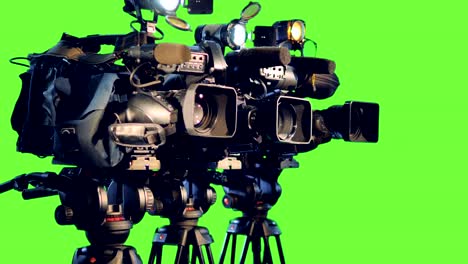 a side view on three professional video cameras.