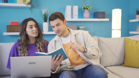 Happy-and-cute-couple-working-from-home-sharing-ideas-with-each-other,-brainstorming.