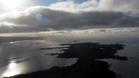 aerial - silhouette of the isle of gigha at sunrise, kintyre, scotland, forward