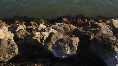 planning shot of sea lapping on rocks at hythe marina