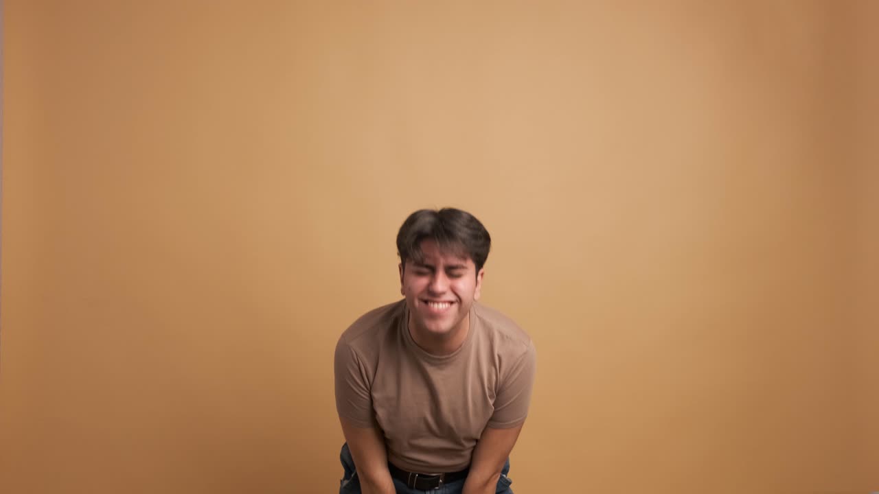 Casual young man jumping and dancing celebrating