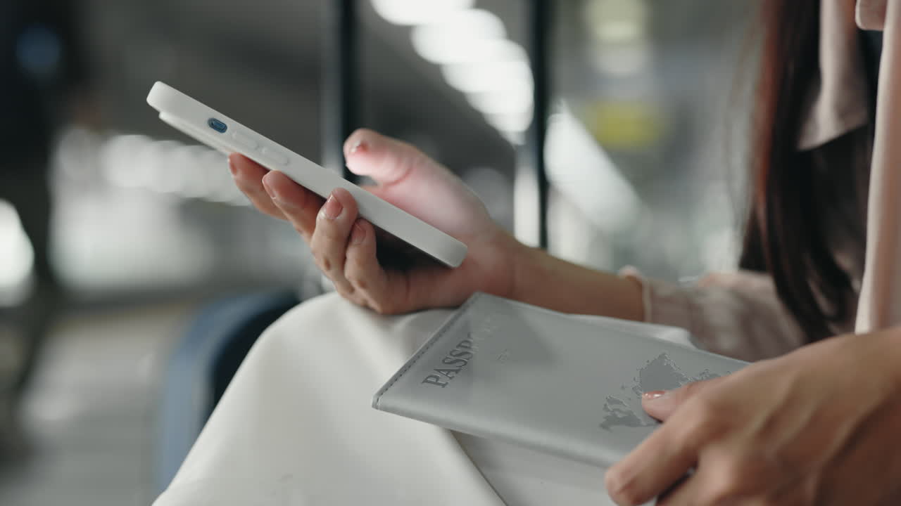Woman holding a mobile phone and a passport