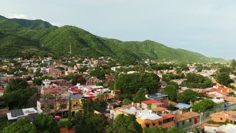 Aerial View of a Town Nestled in Lush Green Mountains