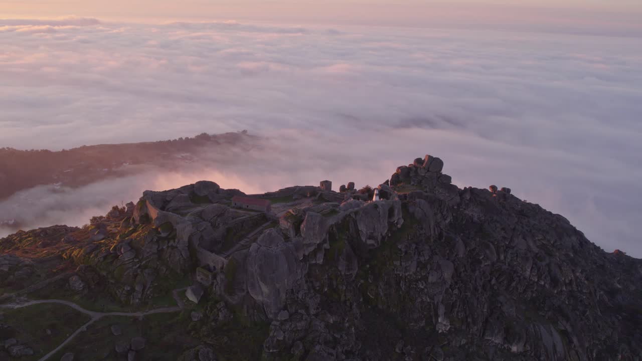 Castelo de Monsanto Ru&iuml;ne Portugal on Mountain top during low clouds morning, aerial