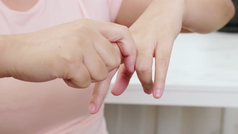 Detail-hands-stretching-and-exercising-to-protect-office-syndrome-and-hand-arthritis-after-work-at-home-office-day