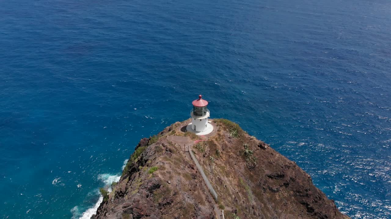 Aerial Flyover and Tilt Down Reveal of Makapuu Lighthouse and Walking Trail in Oahu, Hawaii