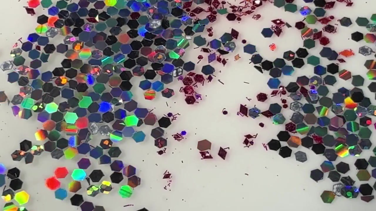 Particelle di glitter esagonali sparse