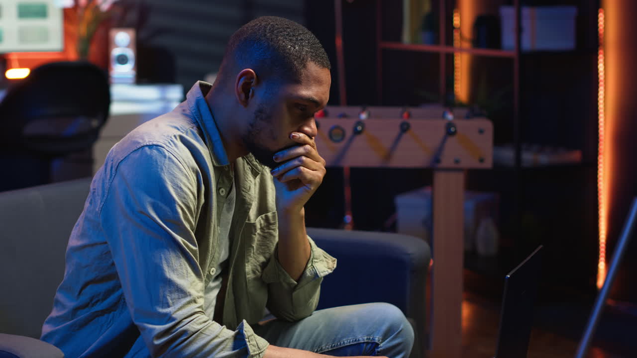 Vertical Video African american guy being overworked with headache at modern loft