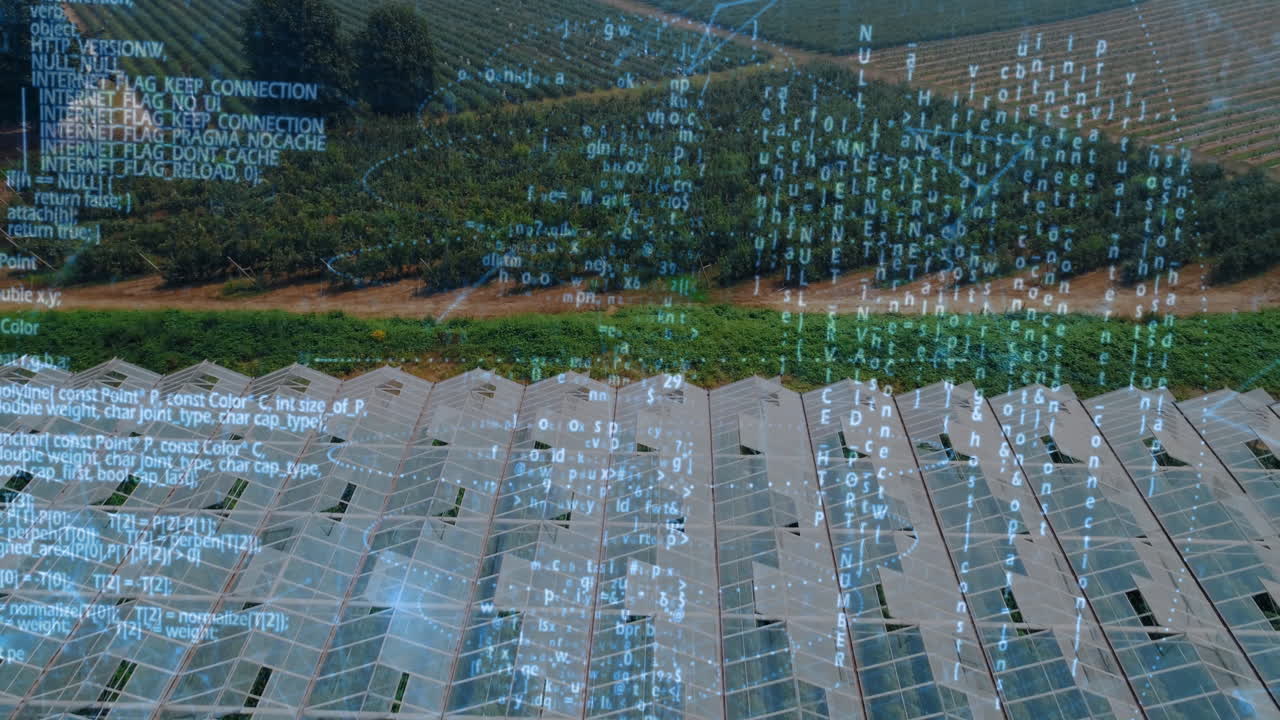 Animation of digital code overlaying aerial view of greenhouses and fields