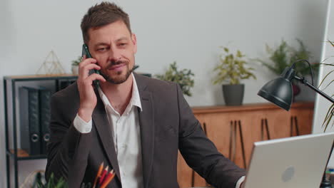 business man in suit working, having mobile phone talk at office workplace using messenger chat apps