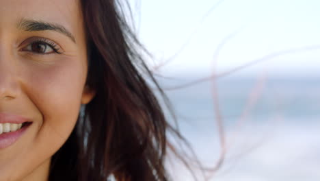 closeup of smiling woman with brown eyes showing