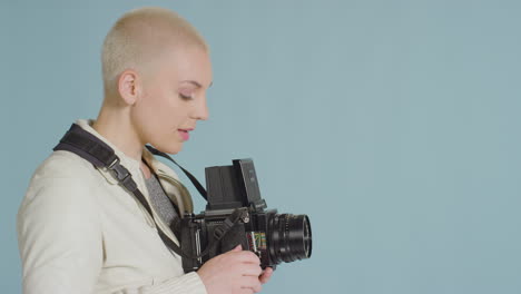 side view of female photographer using medium format film camera 01