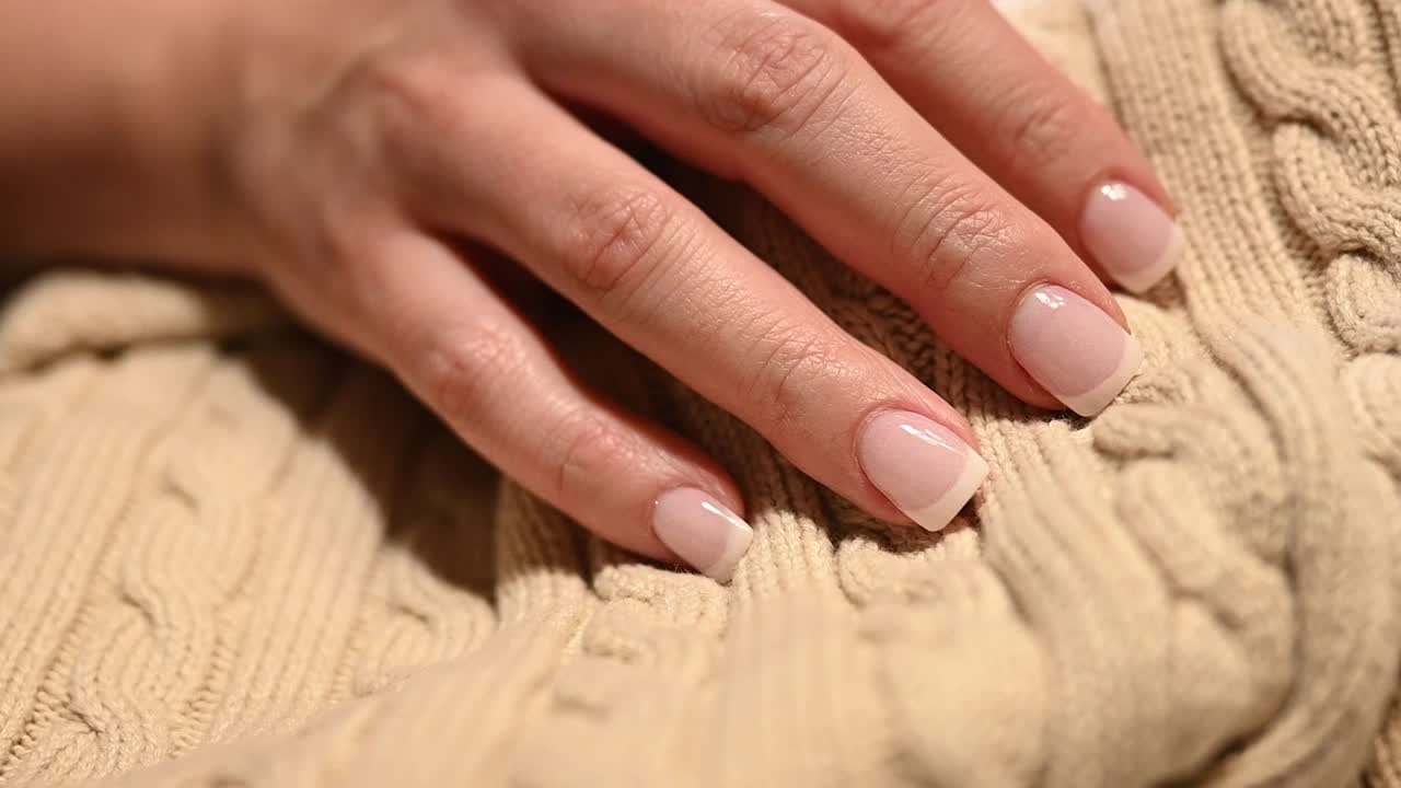 slow slider over perfect French manicured fingernails over a beautiful sweater