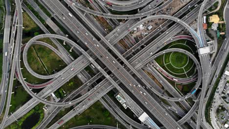 high angle looking top down view of complicate road and expressway intersection in bangkok city of thailand. shot by drone can use for transportation or abstract concept.