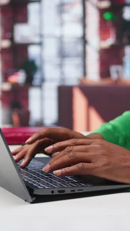 vertical video freelancer creating articles content for his online blog at home desk