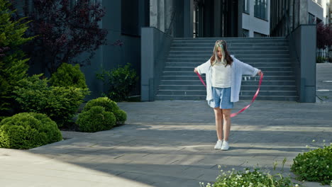 woman dancing with ribbon on city street