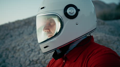 astronaut with helmet looks around and opens helmet visor in new planet