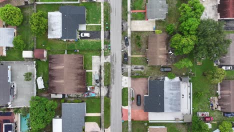 american suburb neighborhood in miami, florida. one family homes with street in suburbia. aerial top down shot.