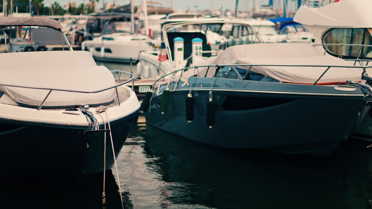 View of white boats docked in the harbour of Golfe-Juan, France on a cloudy day