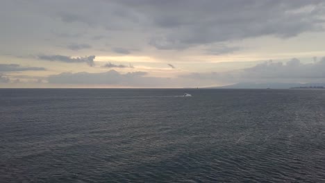 white luxury motorboat surrounded by dark blue stormy sea, wide shot