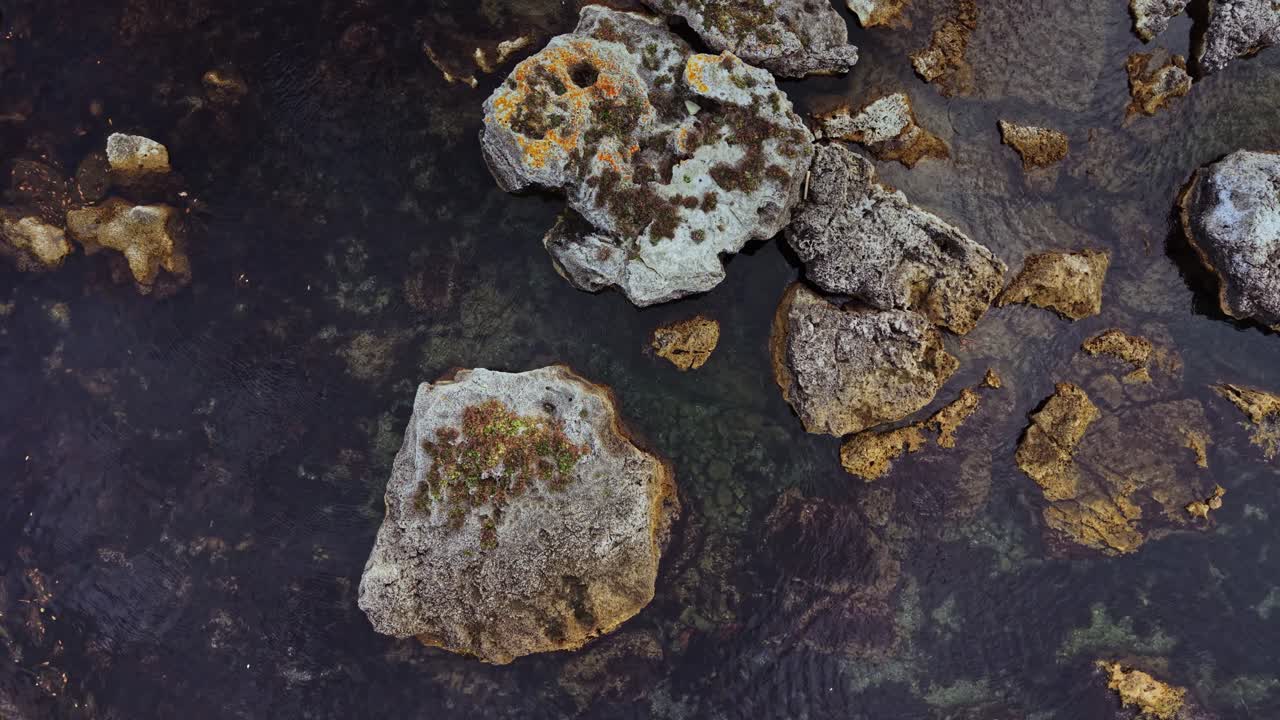 Scenic aerial view of rocky formations surrounded by clear water